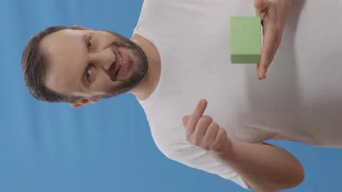 Young man with a beard in front of a blue background Stock Footage 151985778