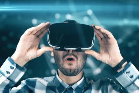 A young man with a beard in glasses of virtual reality on a technological bac Stock Illustration