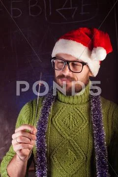 Young man with beard in a green knitted sweater Stock Photos
