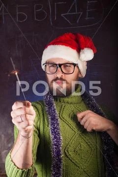 Young man with beard in a green knitted sweater Stock Photos