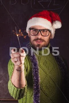 Young man with beard in a green knitted sweater Stock Photos