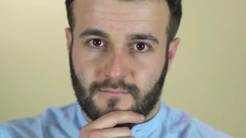 A young man with a beard looking at camera Stock-Footage 72572804