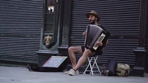 Young man with beard playing accordion on a tourist street in portugal lisbon Stock Footage 205966219