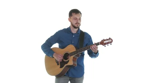 Young man with a beard playing acoustic guitar. White background. Isolated Stock Footage 135252146