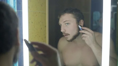 Young man with a beard shaves whiskey Stock Footage 113232401