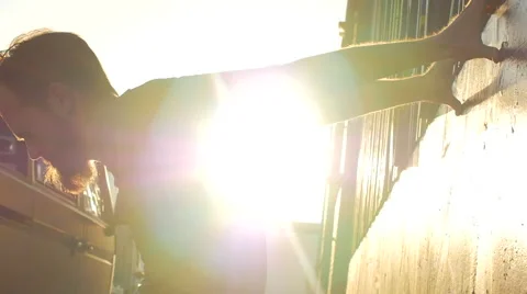 A young man with a beard stretching and working out in urban environment, slow m 動画素材 68537417