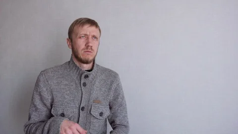 Young man with a beard suffers from illness Stock Footage 128300775