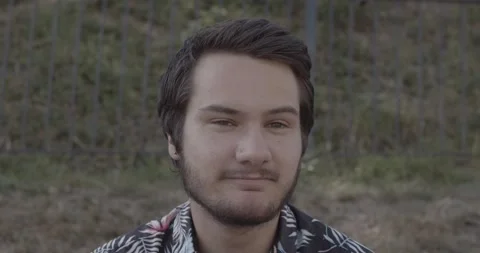 Young man with a beard is talking, agreeing and smiling Stock Footage 136762006