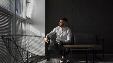 Young man with a beard turning his head and look at camera. Business man in 動画素材 113201863