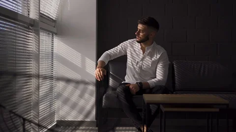 Young man with a beard turning his head and look at camera. Business man in Stock-Footage 113608105
