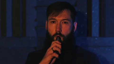 Young man with beard vaping an electronic cigarette. Vaper hipster smoke Stock Footage 80985379