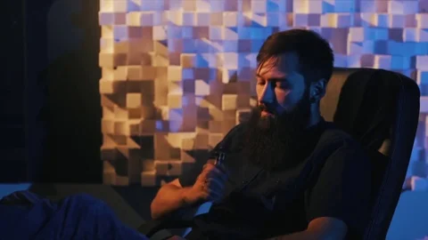 Young man with beard vaping an electronic cigarette. Vaper hipster smoke Stock Footage 80985570