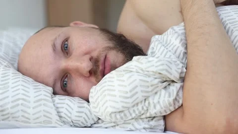 A young man with a beard woke up Video stock 242720324