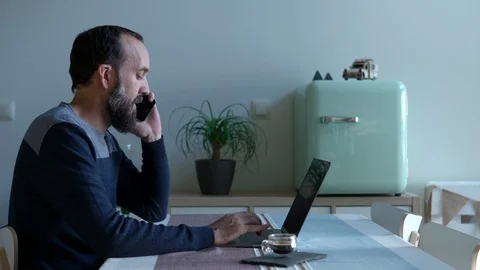 Young man with a beard working with his laptop in his modern home. Stock Footage 122386734