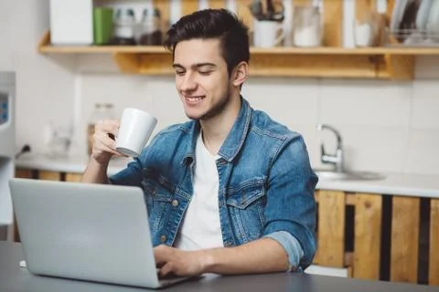 Young man with beard working on laptop Stock Photos