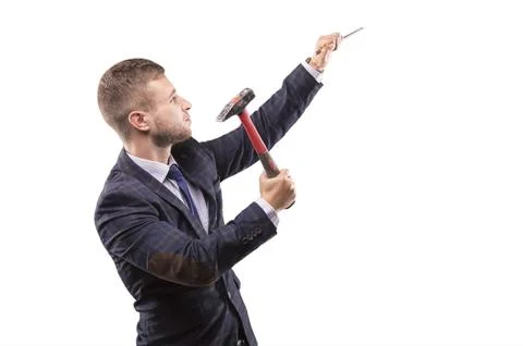 Young man beats hammer on the chisel Stock Photos