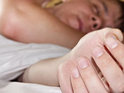 Young man in the bed Stock Photos