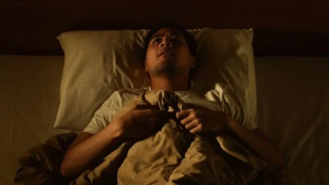 Young man in bed suffering insomnia. Nightmare issues . Stock Footage 125174548