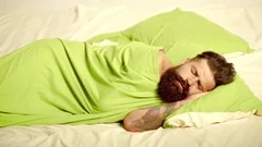 Funny Man lying in bed and sleeping. Att... | Stock Video | Pond5