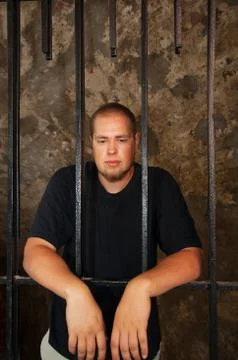 Young man behind the bars Stock Photos