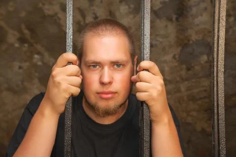 Young man behind the bars Stock Photos