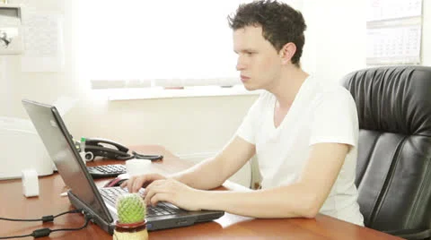 Young man behind the laptop 스톡 동영상 22669432