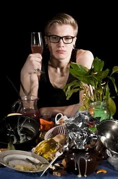 Young man behind uncleared table Stock Photos