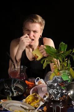 Young man behind uncleared table Stock Photos