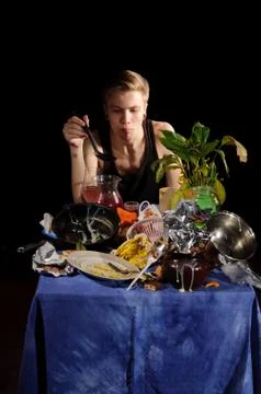 Young man behind uncleared table Stock Photos