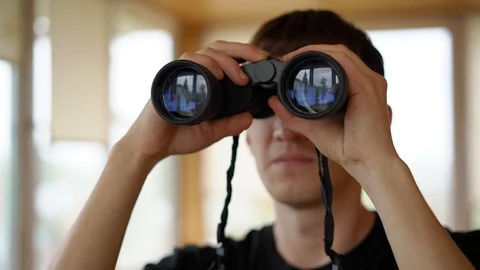 A young man with binoculars 스톡 동영상 90434335