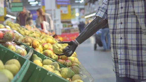 Young man with a bionic prosthetic arm in a supermarket shopping Stock Footage 119072683