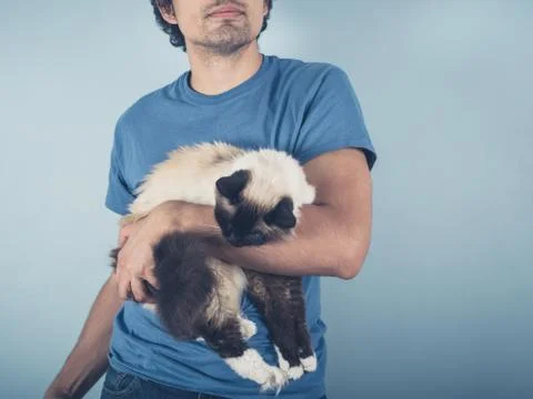 Young man with Birman cat 스톡 사진