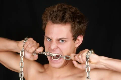 Young man biting a chain Stock Photos