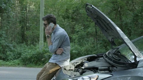 Young Man in Black Glasses Checking the Engine of his Car Stock Footage 79937618