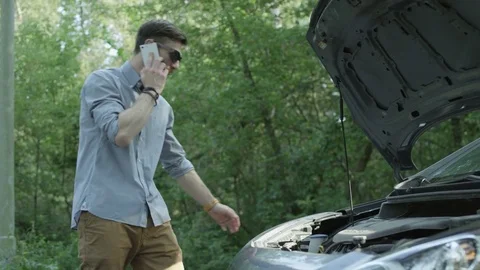 Young Man in Black Glasses Checking the Engine of his Car Stock Footage 79937646