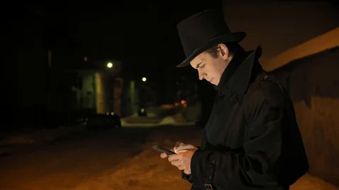 A young man in a black hat uses the phone. Stock-Footage 103365378