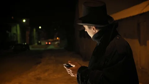 A young man in a black hat uses the phone. Stock-Footage 103365577