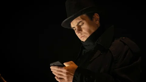 A young man in a black hat uses the phone. Stock-Footage 103365789