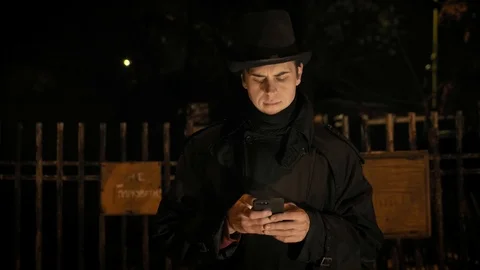 A young man in a black hat uses the phone. Stock-Footage 103365897