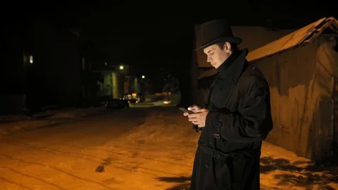 A young man in a black hat uses the phone. Stock-Footage 103366271