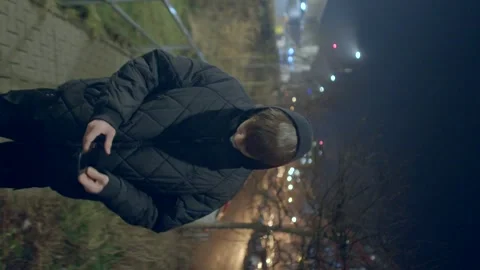 A young man in a black jacket navigates the citys nightlife Stock Footage 311204709