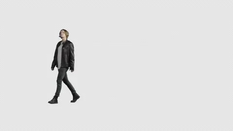 A young man in a black leather jacket walks and looks around. Cut out video Stock Footage 167479143
