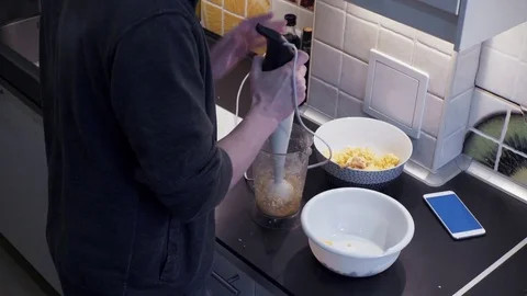 Young man with blender preparing vegetable food at home kitchen and smartphone Stock Footage 74159207