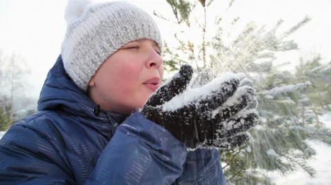Young man Blows Snowflakes Video stock 33805804