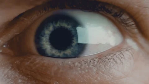 Young man blue iris eye macro shot. Eyeball with blue pupil and blood vessels is Stock Footage 136472827