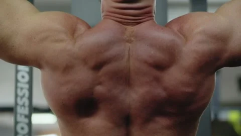 Young man bodybuilder is doing pull up in the gym on the horizontal bar Stock Footage 257800920