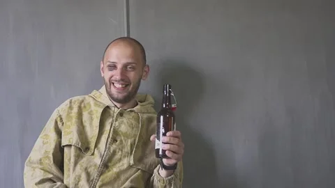 A young man with a bottle. The problem of alcohol addiction. Withdrawal pains Video stock 131143309