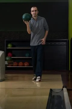 Young man bowling Stock Photos