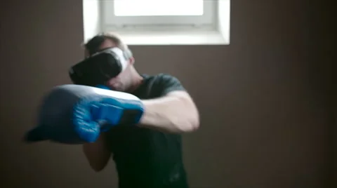 Young man boxing wearing VR glasses Stock Footage 62727645