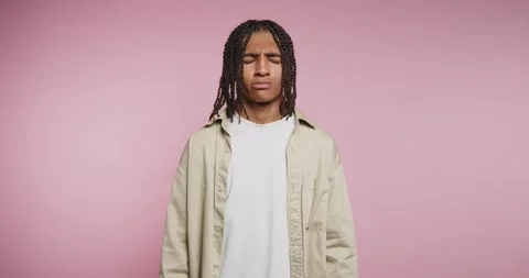 Young man with braids conveys deep emotions in a creative portrait shoot ag.. Видео 329112746